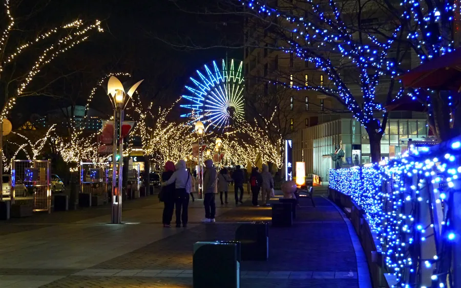 Illuminated waterfront promenade at Kobe Harborland at night