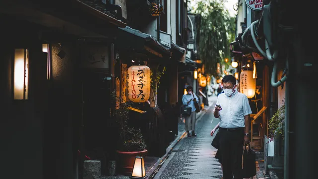 Pontocho Alley in Kyoto lit by paper lanterns at dusk