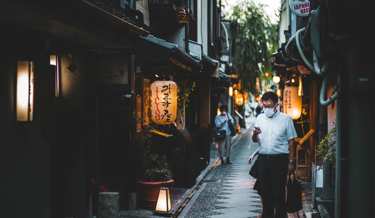 Pontocho Alley in Kyoto lit by paper lanterns at dusk