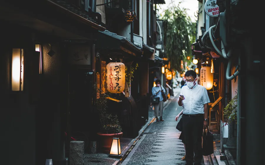 Pontocho Alley in Kyoto lit by paper lanterns at dusk