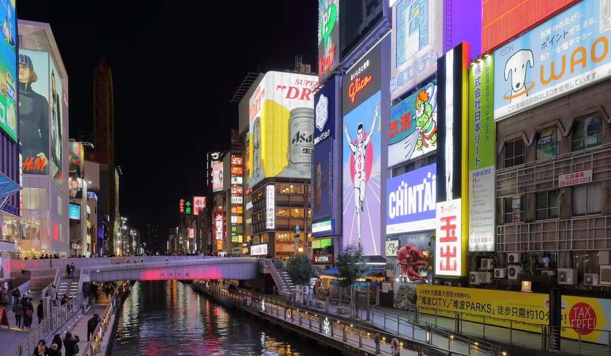Dotonbori canal lit up with neon signs at night