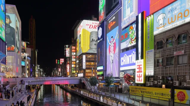 Dotonbori canal lit up with neon signs at night