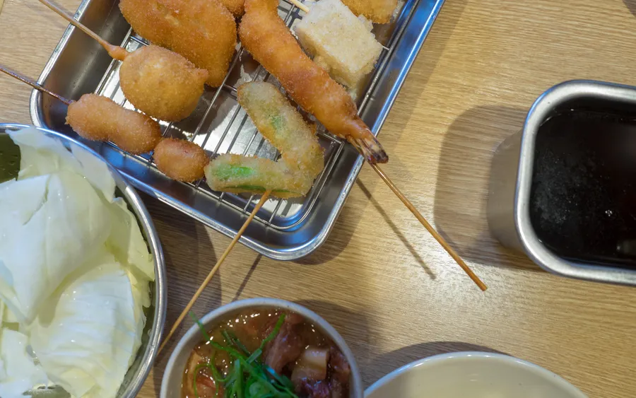 A plate of deep-fried kushikatsu skewers