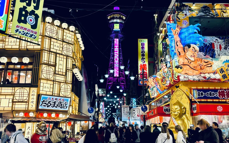 Tsutenkaku Tower lit up above the streets of Shinsekai