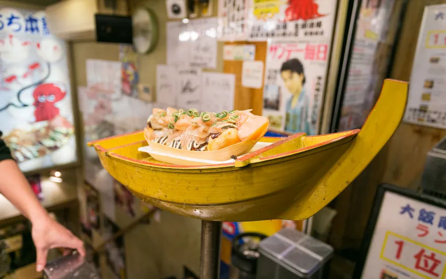Takoyaki served in a boat-shaped tray